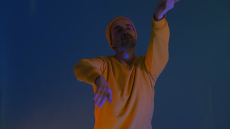 Man-dancing-with-hands-isolated-on-blue-background.-Party-music-lifestyle-radio-and-disco-concept